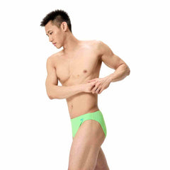 Speedo men's solid brief in screaming green, featuring a snug fit and classic design for swimming and poolwear.