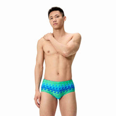 Speedo men's printed 13.5cm brief featuring quilt triangle design in blue and green, made from quick-drying swimwear fabric.