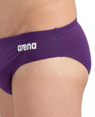 Arena men's solid team swim briefs in plum and white, featuring a snug fit and supportive design for competitive swimming.