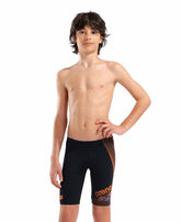 Arena boys' swim jammer in black with orange and turquoise design, featuring a sleek fit for competitive swimming.