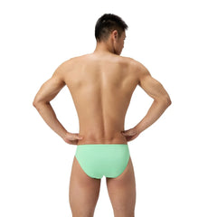 Speedo men's ML solid brief in alfalfa green, close-up view showing the snug fit and elastic waistband of the swimwear.