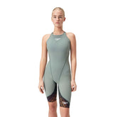 Speedo Women's Fastskin LZR Ignite Kneeskin in green and orange, close-up view of the sleek, fitted swimwear designed for competitive swimming.