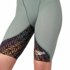 Speedo Women's Fastskin LZR Ignite kneesuit in green and orange, showcasing a sleek, form-fitting design for competitive swimming.