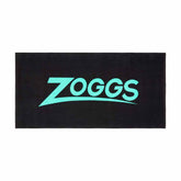 Black and turquoise Zoggs swimming pool towel displayed folded with the Zoggs logo visible on the fabric.