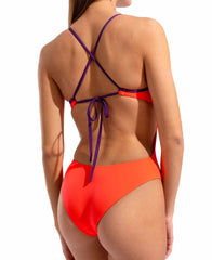 Arena women's solid tie-back swimsuit in bright coral and plum, featuring a sleek design and adjustable back straps.