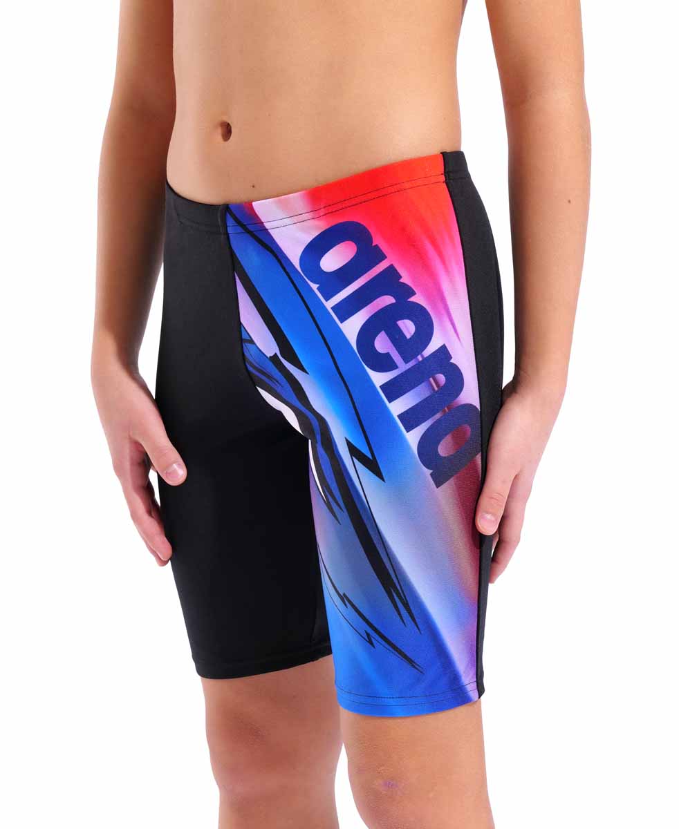 Black and multi-colored Arena boys' Loud swim jammer showing a close-up of the fitted swimwear with logo details.