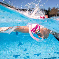Finis Stability Snorkel in orchid color, designed for comfortable underwater breathing, shown with adjustable straps and mouthpiece.