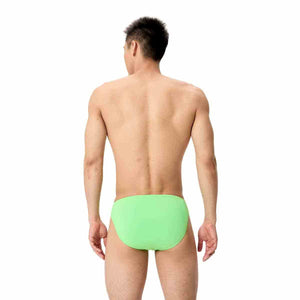Speedo men's solid brief in screaming green, close-up of the snug, elastic waistband and vibrant swimwear fabric.