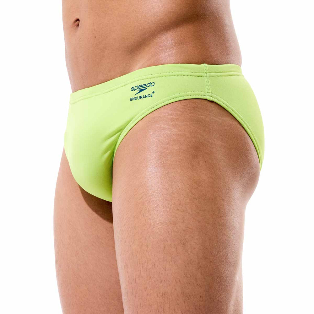 Speedo men's solid citrus green swim briefs with a snug fit and elastic waistband, designed for comfortable swimming.