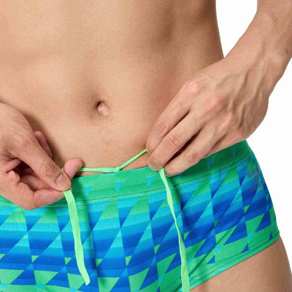 Speedo men's printed 13.5cm brief with quilt triangle pattern in blue and green, designed for comfortable swimwear.