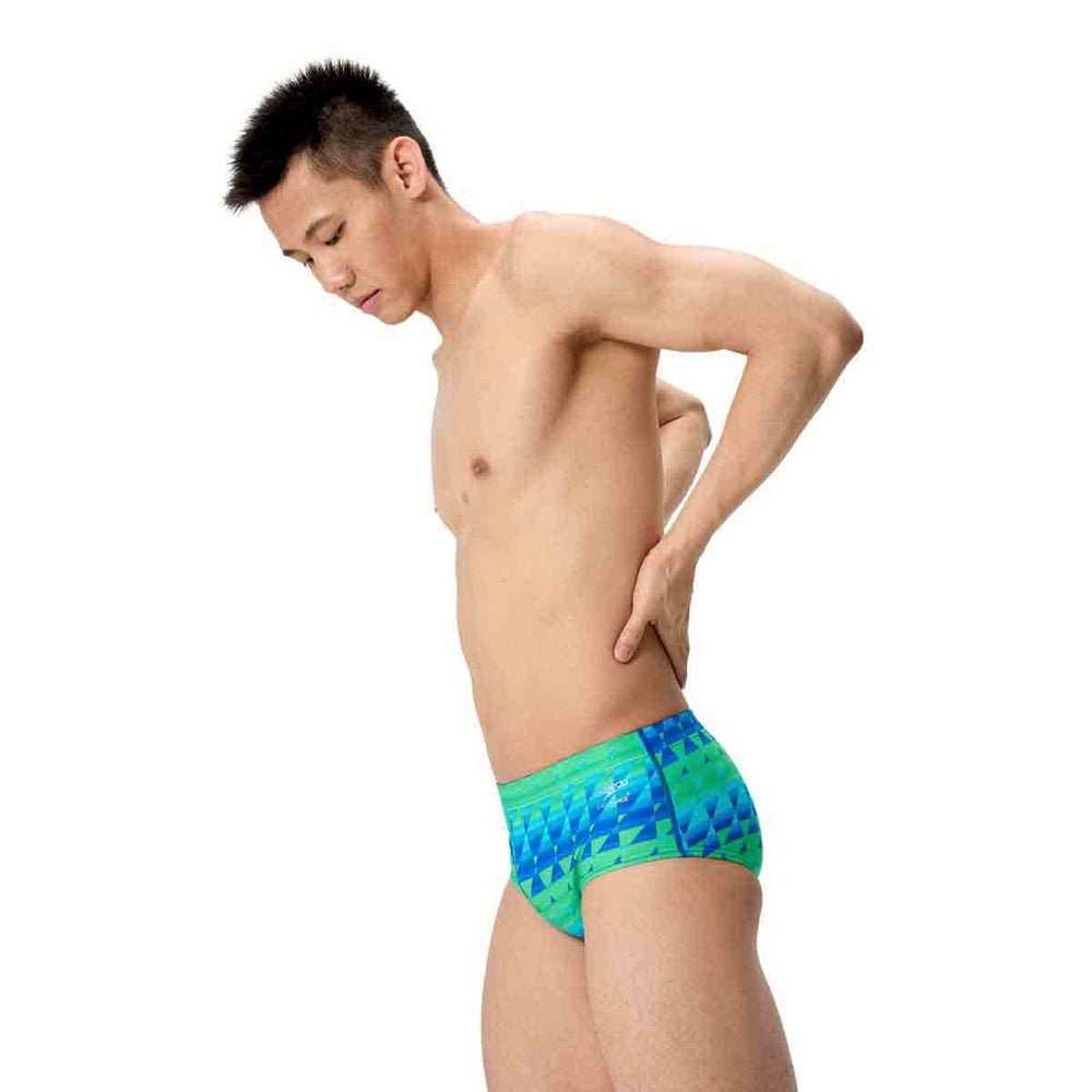 Speedo men's printed swim briefs with quilt triangle pattern in blue and green, featuring a 13.5cm brief cut.