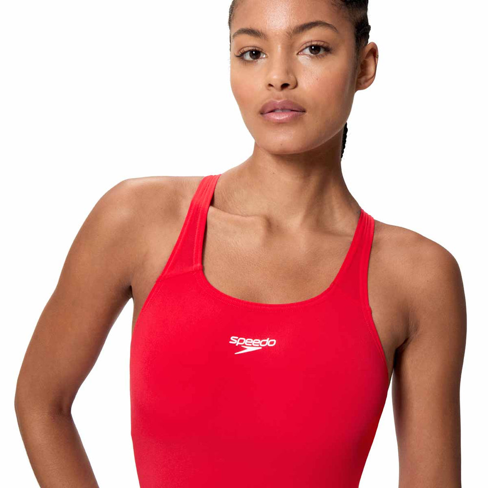 Speedo Women's Endurance+ Legsuit in High Risk Red, close-up of the red swimsuit fabric and sleek design for competitive swimming.