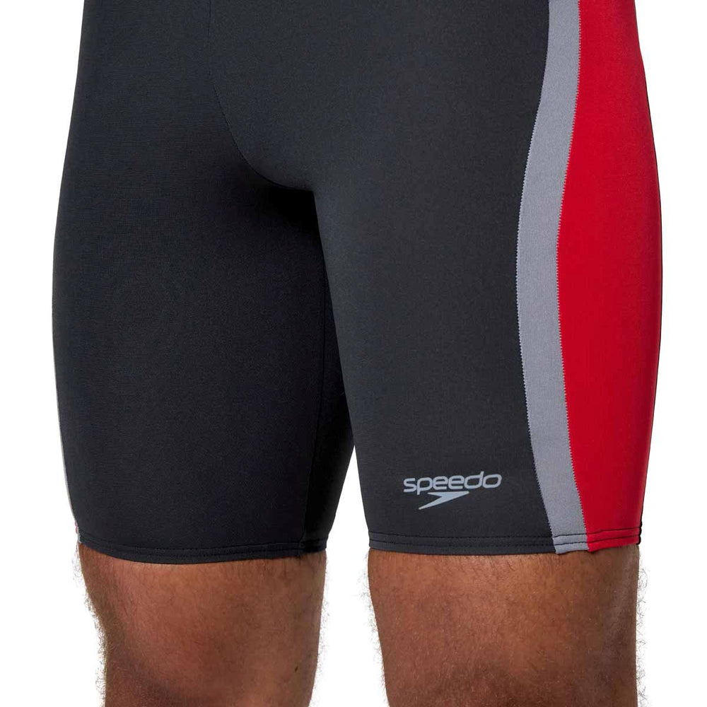 Speedo men's solid splice jammer in anthracite and high risk red, with a close-up view of the snug-fitting swimwear fabric.
