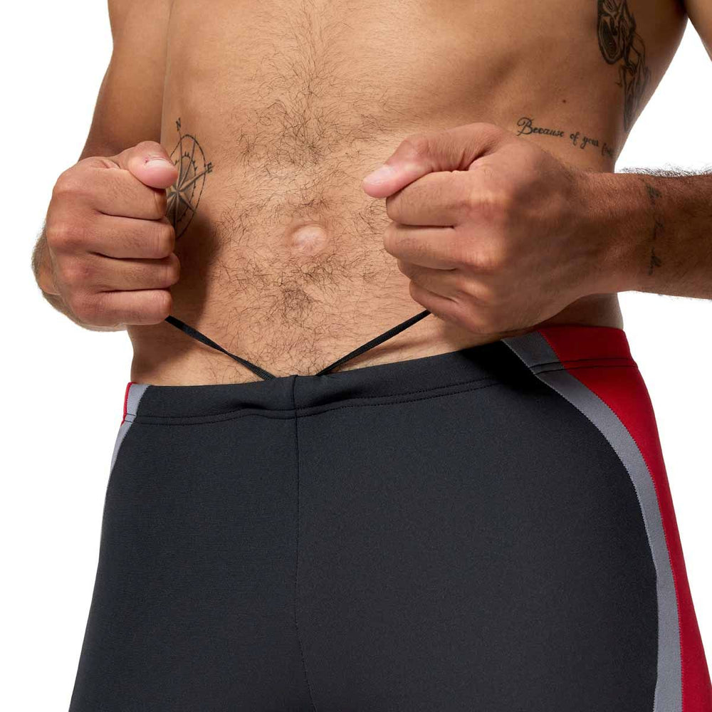 Speedo men's solid splice jammer swimsuit in anthracite and high risk red, featuring a sleek, fitted design for competitive swimming.