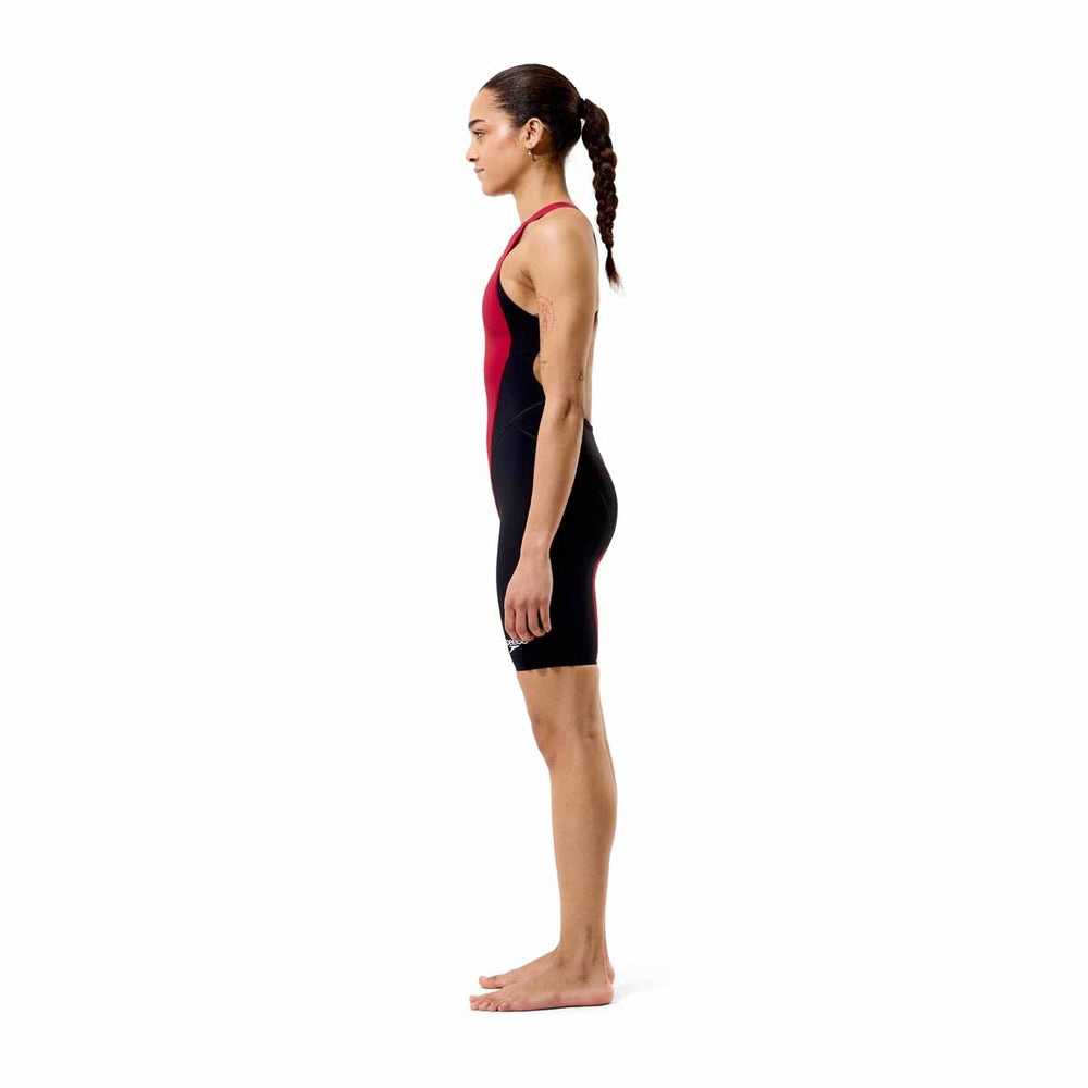 Speedo Women's Fastskin LZR HyperPro kneesuit in regal red and black, close-up view showing sleek, form-fitting swimwear design.