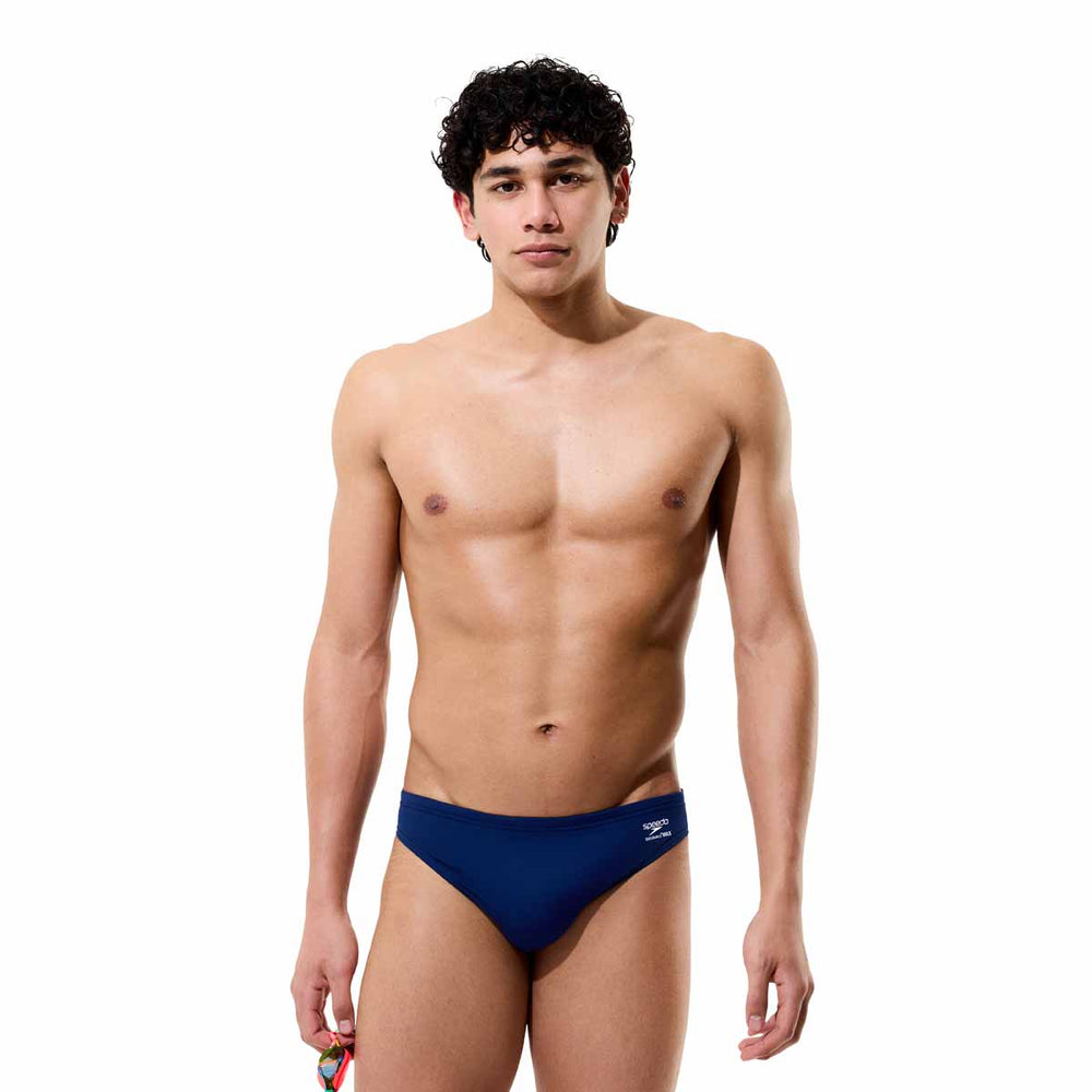Speedo men's Solid Endurance+ Max Brief in Team Navy, showing close-up of navy swim briefs with waistband and brand logo.