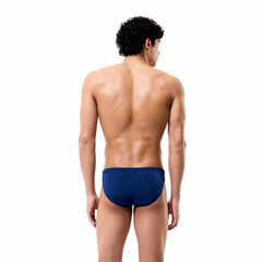 Speedo men's solid Endurance+ Max brief in team navy, close-up of navy swim briefs with Speedo logo and elastic waistband.
