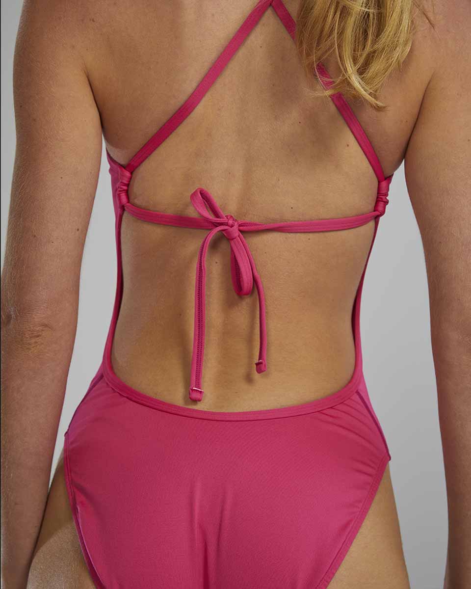 TYR Women's fuchsia crosscut tieback swimsuit with sleek design and supportive straps, ideal for swimming and beachwear.