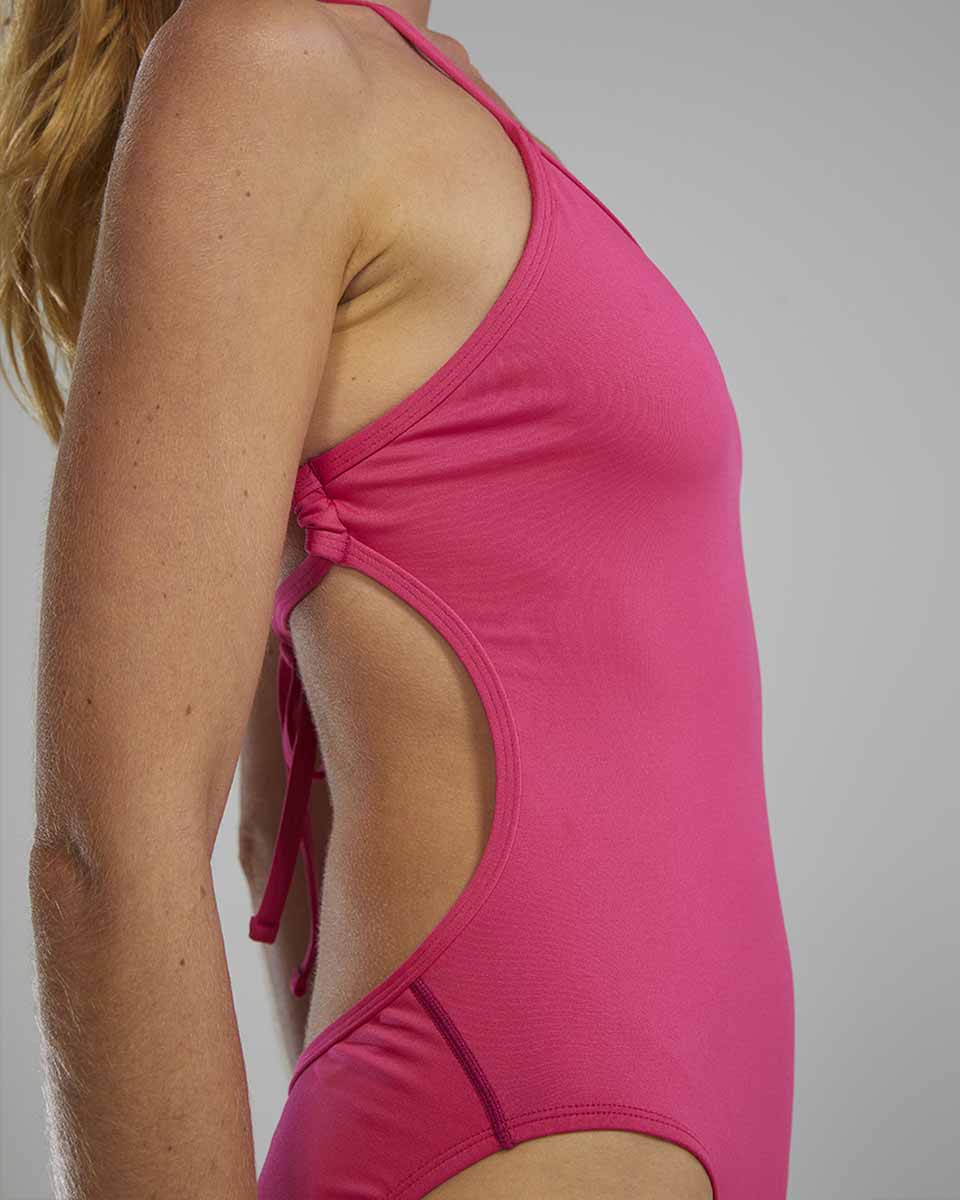 TYR women's solid fuchsia crosscut tieback swimsuit with sleek design and secure fit, suitable for swimming and water activities.