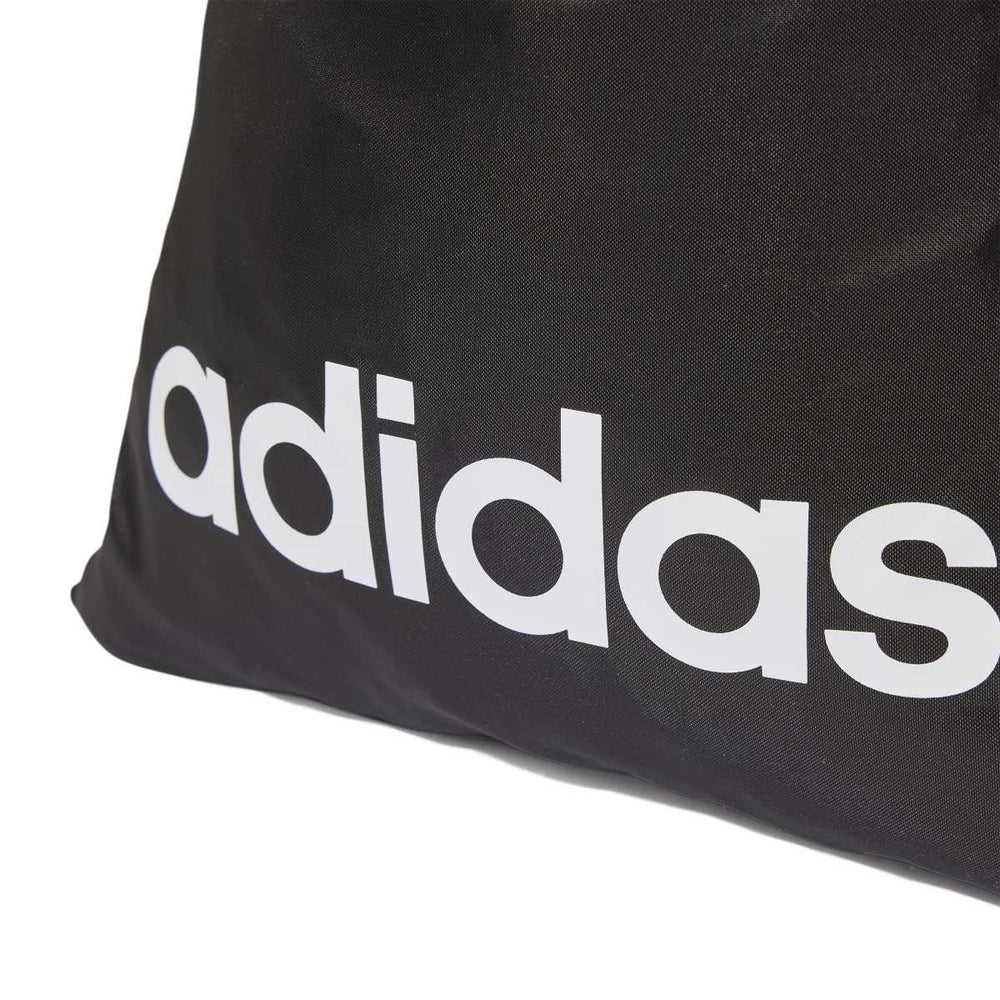 Black Adidas Linear gym sack used as a swim bag, showing the Adidas logo and durable fabric design.