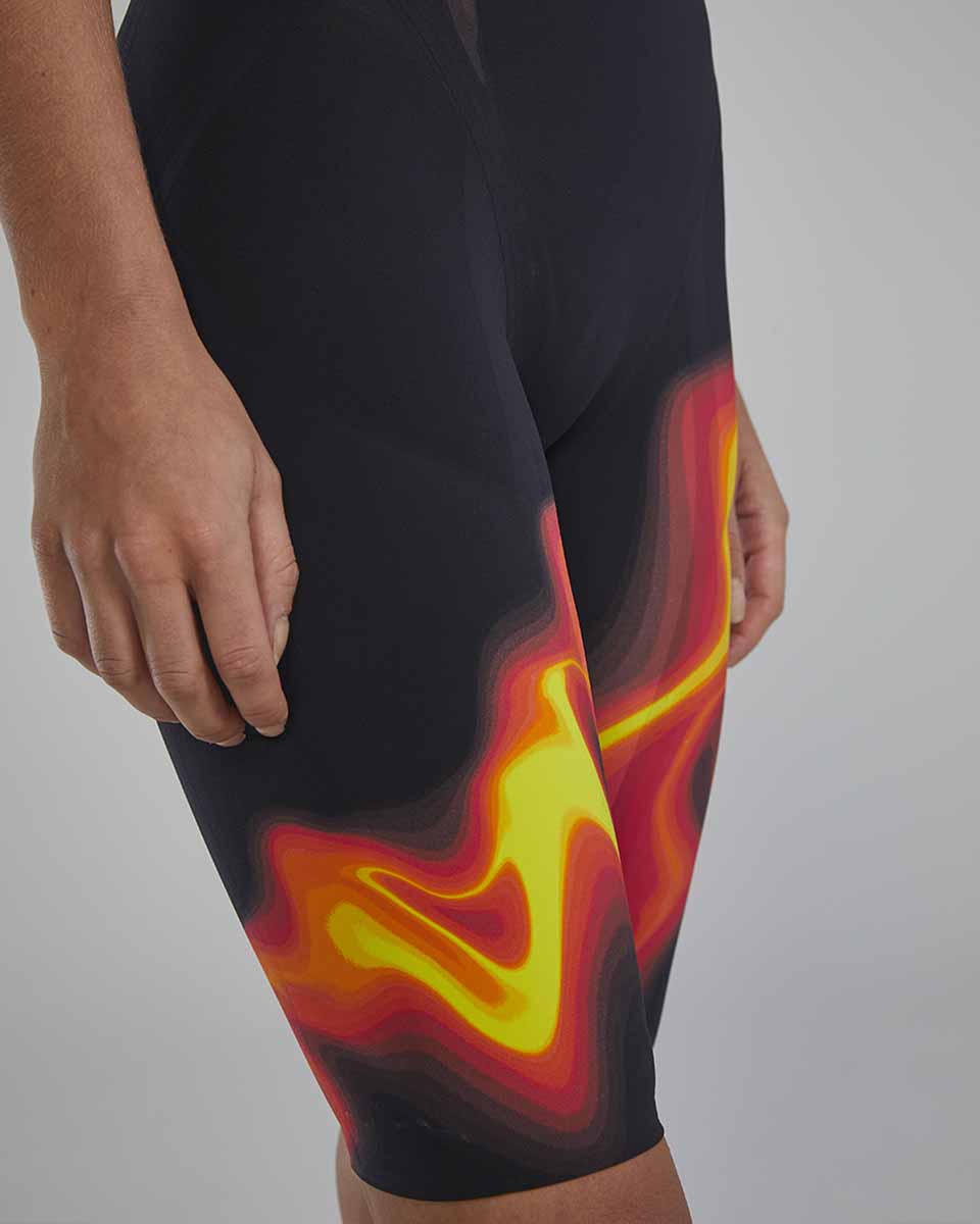 TYR Womens Venzo Infrared Openback Kneeskin in fire color, close-up showing sleek design and open back style for competitive swimming.