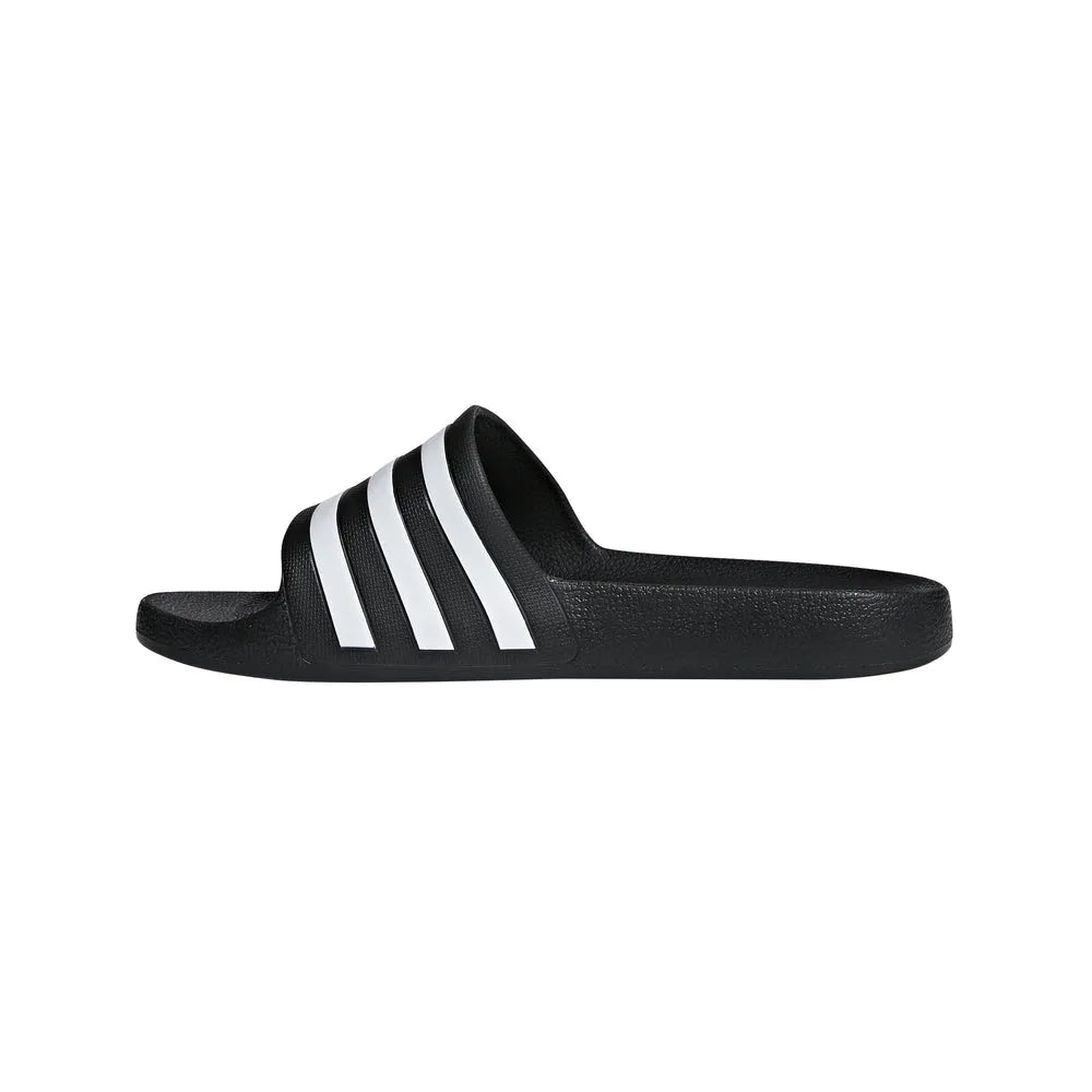 Black Adidas Adilette Aqua Slides on a model's feet, showcasing the sporty slide design and comfortable fit.