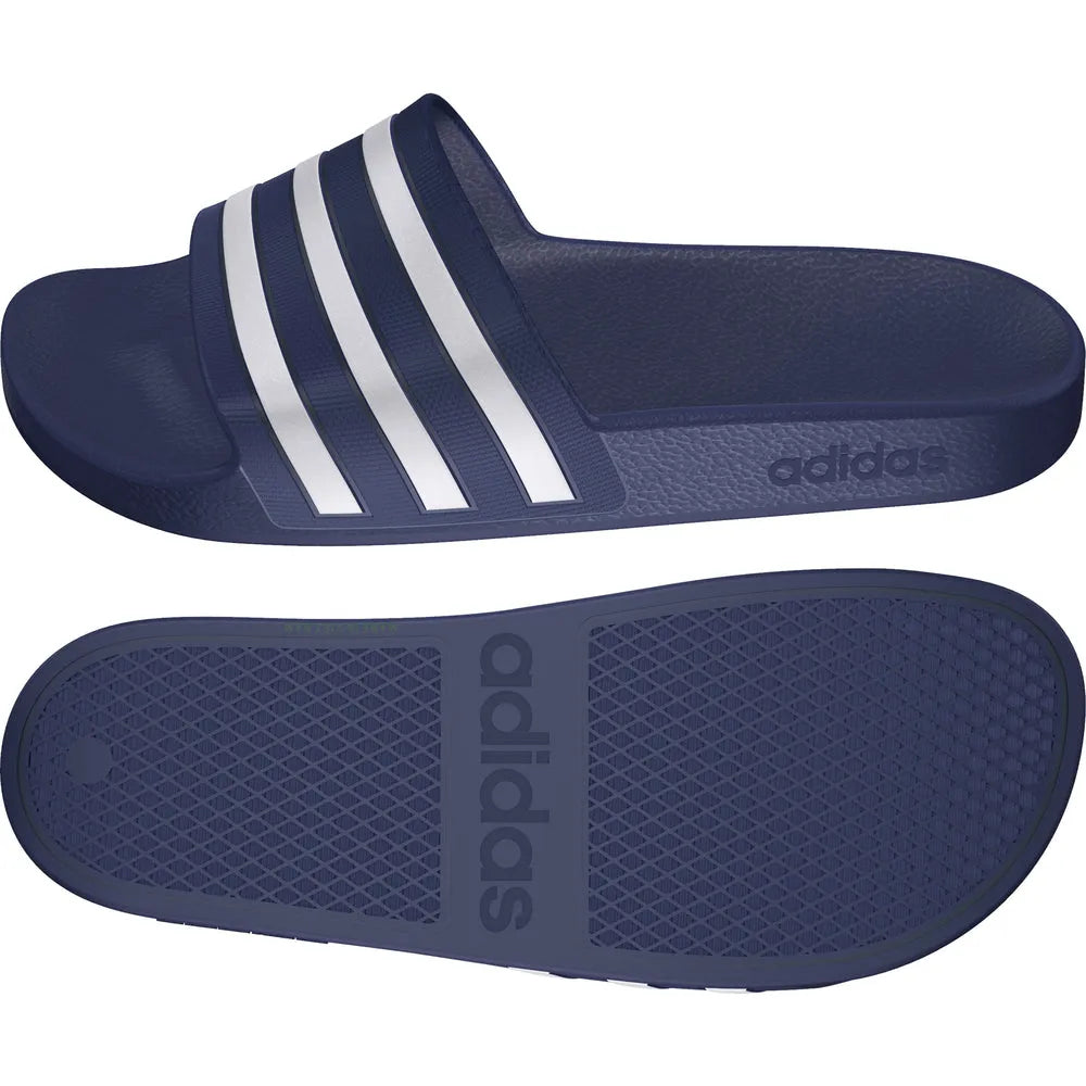 Navy blue Adidas Adilette Aqua Slides with textured footbed and slip-on design, paired with sports socks.