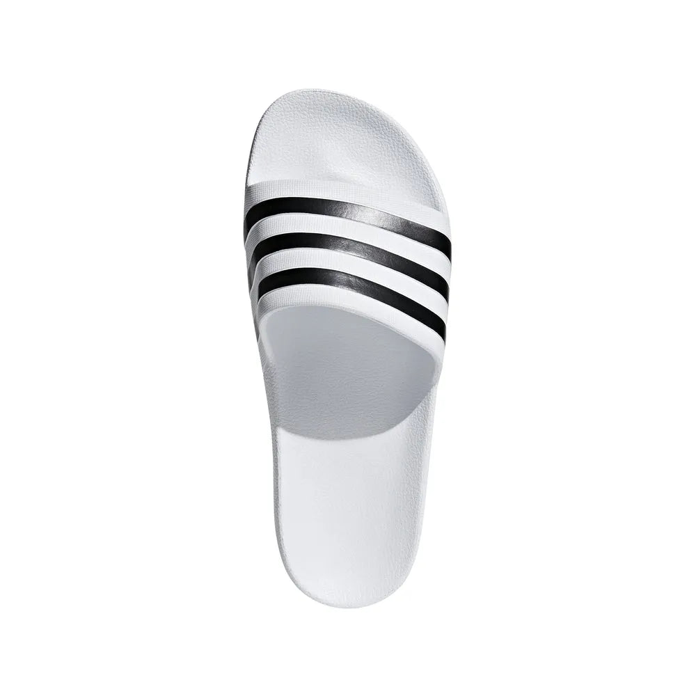 White Adidas Adilette Aqua Slides shown with sports socks, featuring a slip-on design and cushioned sole for beach or casual wear.