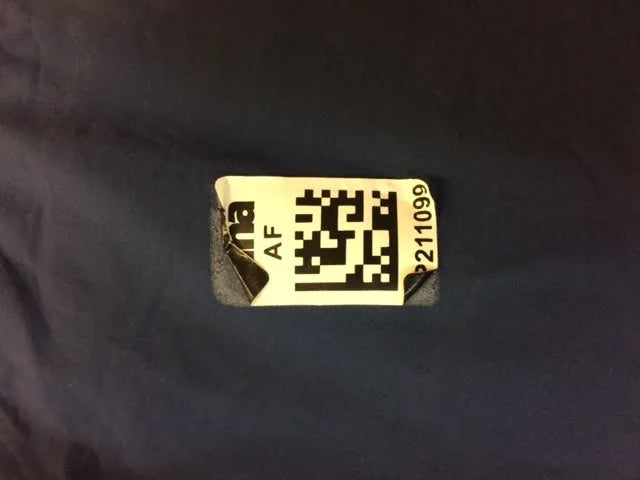 AK race suit repair service showing a close-up of a repaired racing suit with visible stitching and fabric details.