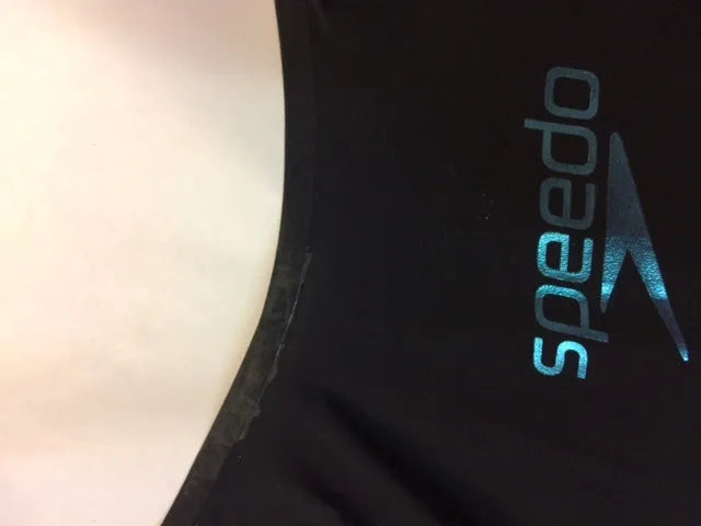 AK race suit repair service, showing a professional repair process for racing suits with detailed stitching and fabric.