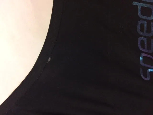 AK race suit repair service, showing a close-up of a damaged race suit being repaired with specialized tools.