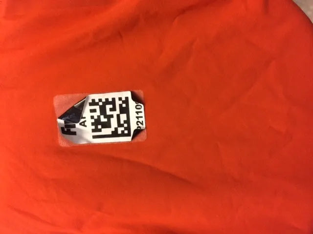 AK race suit repair service, showing a close-up of a professionally patched and restored racing suit fabric repair process.