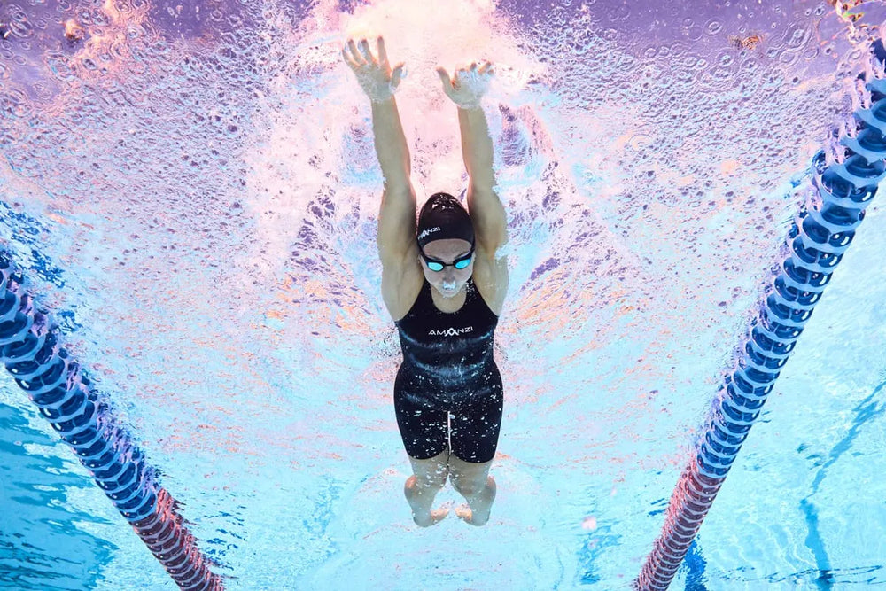 Amani Girls Acceler8 RIZE Kneesuit in Jet and Spearmint, featuring a sleek design and vibrant colors for active swimming or water sports.
