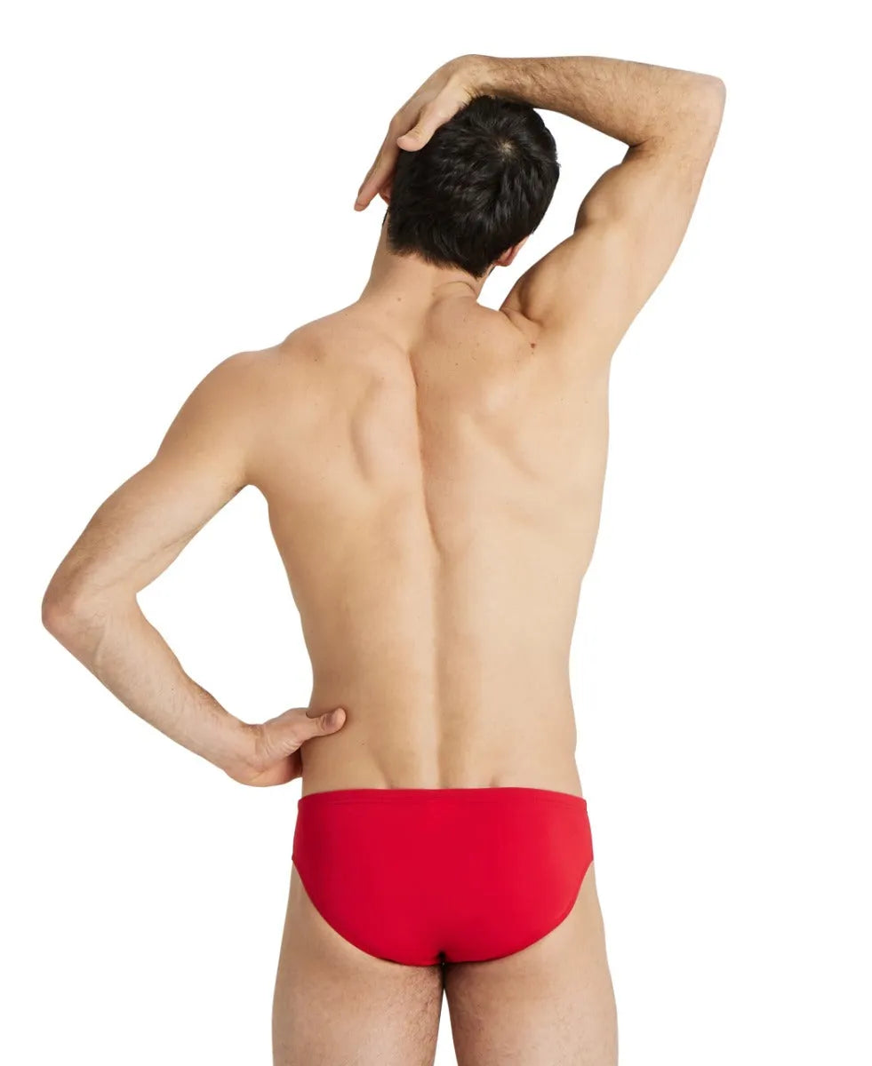 Arena men's team swim solid briefs, close-up of blue swim briefs with elastic waistband and brand logo on the front.