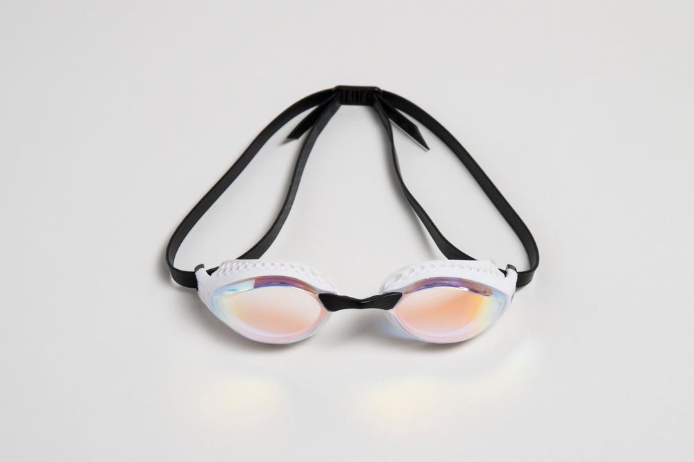Arena Airspeed Mirror goggles in white and copper with mirrored lenses, designed for competitive swimming.