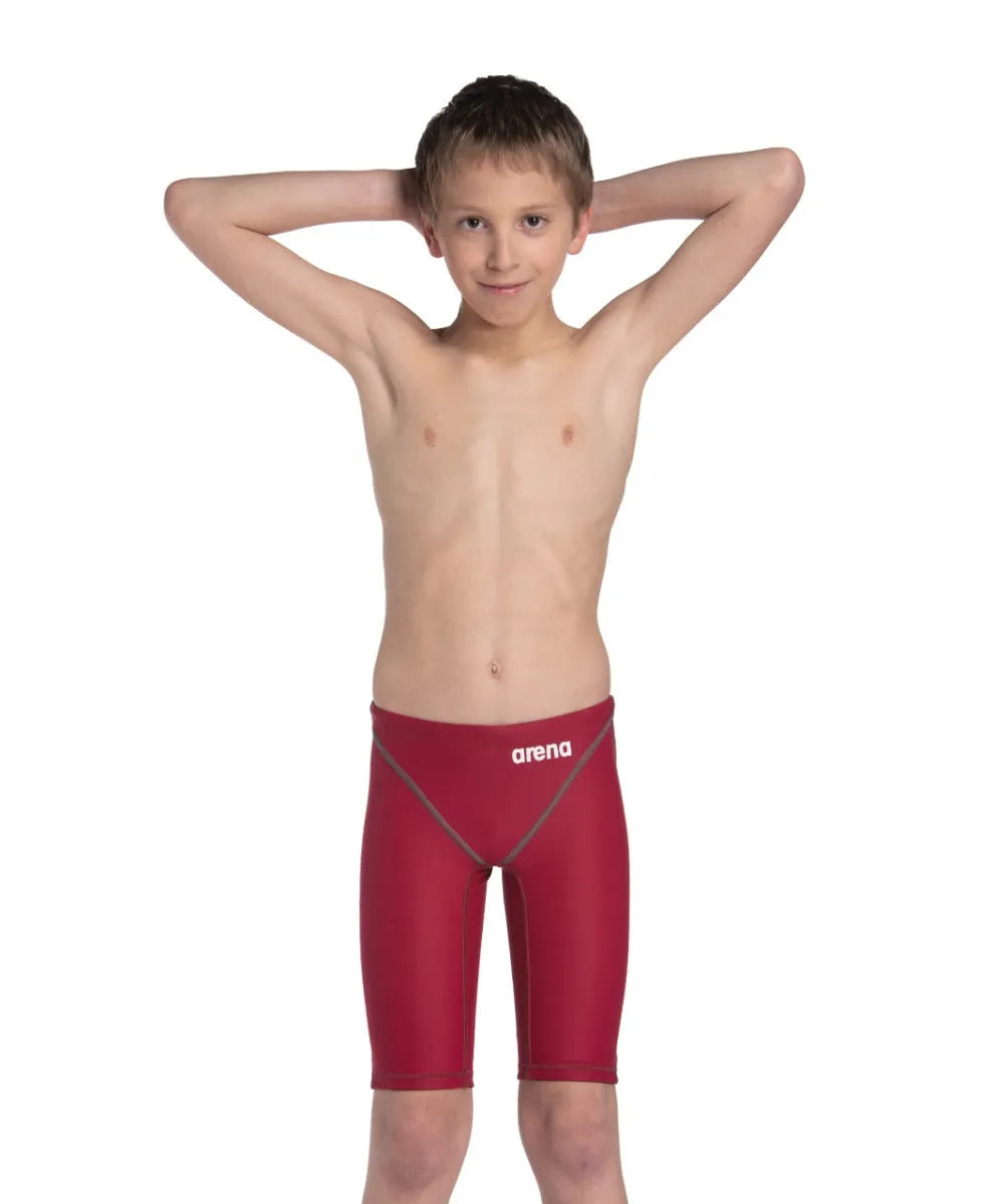 Arena Boys Powerskin ST Next Jammer in deep red, close-up of the competitive swim jammers with sleek fabric and branding details.