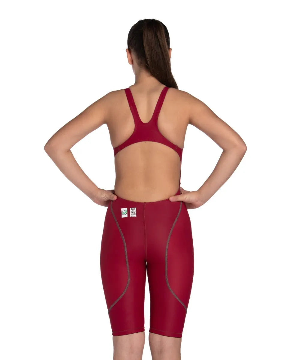 Arena Girls Powerskin ST Next kneesuit for girls in deep red, featuring a sleek, form-fitting design for swimming performance.