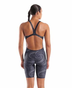 Arena women's printed full-body swimsuit, black kneesuit with colorful patterns, designed for competitive swimming.