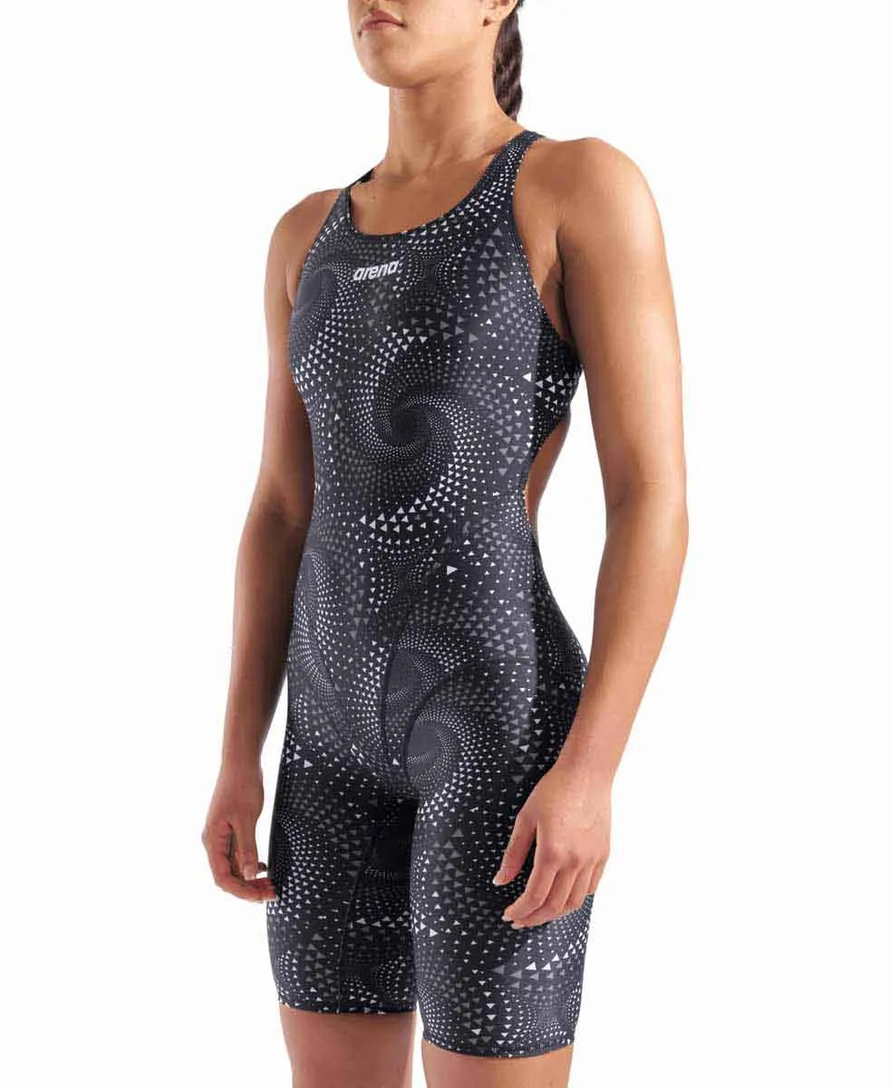 Arena Women's printed full-body swimsuit, black kneesuit with colorful design, designed for competitive swimming and training.