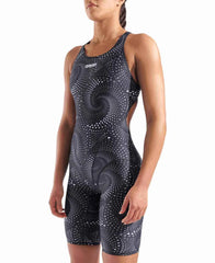 Arena Women's printed full-body swimsuit, black kneesuit with colorful design, designed for competitive swimming and training.
