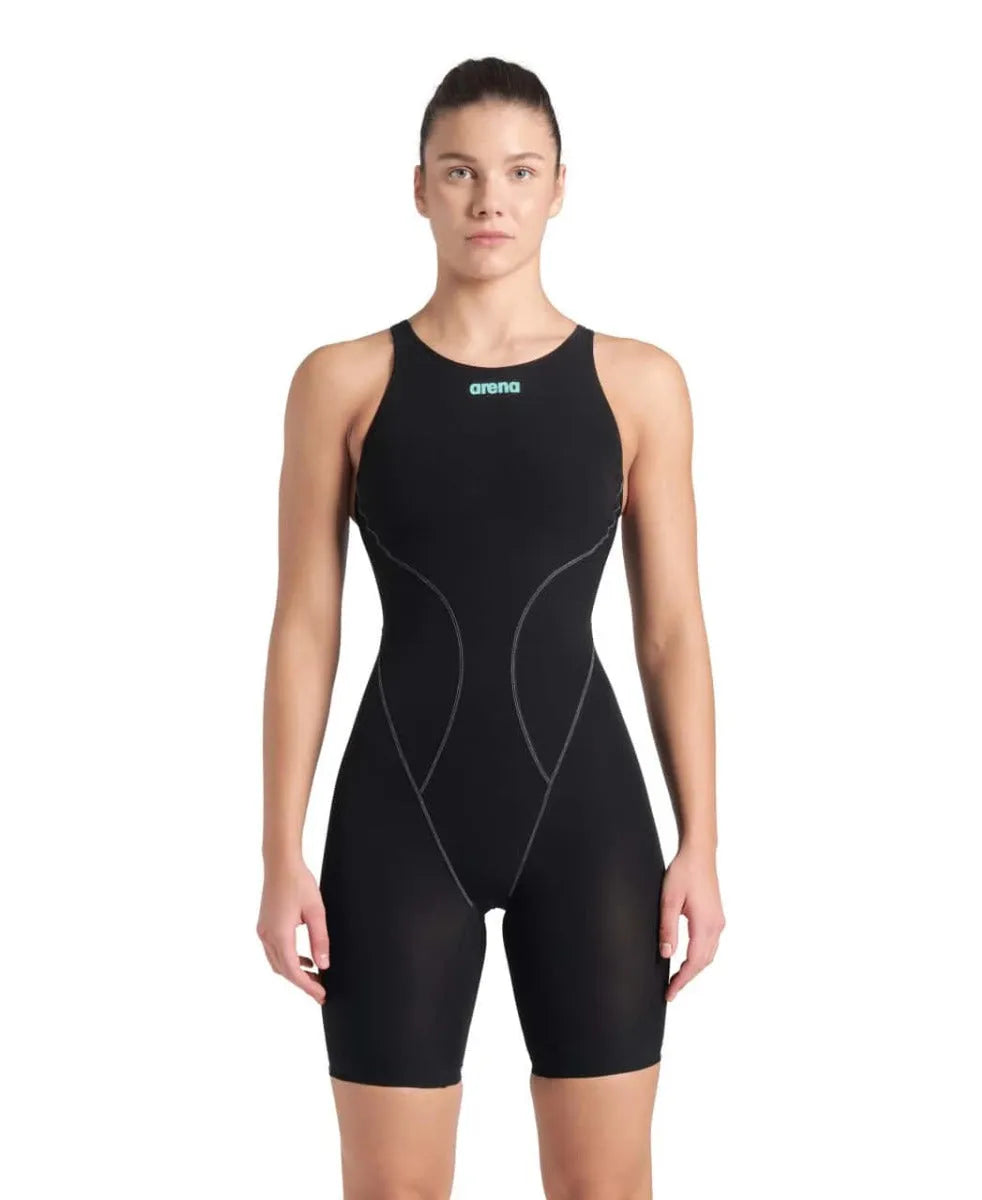 Arena Women's Powerskin Impulso openback kneesuit in black and teal, shown on a model highlighting its sleek design and open back.