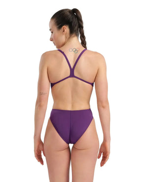 Arena women's solid Team Challenge swimsuit in plum and white, with a sleek, supportive design for competitive swimming.