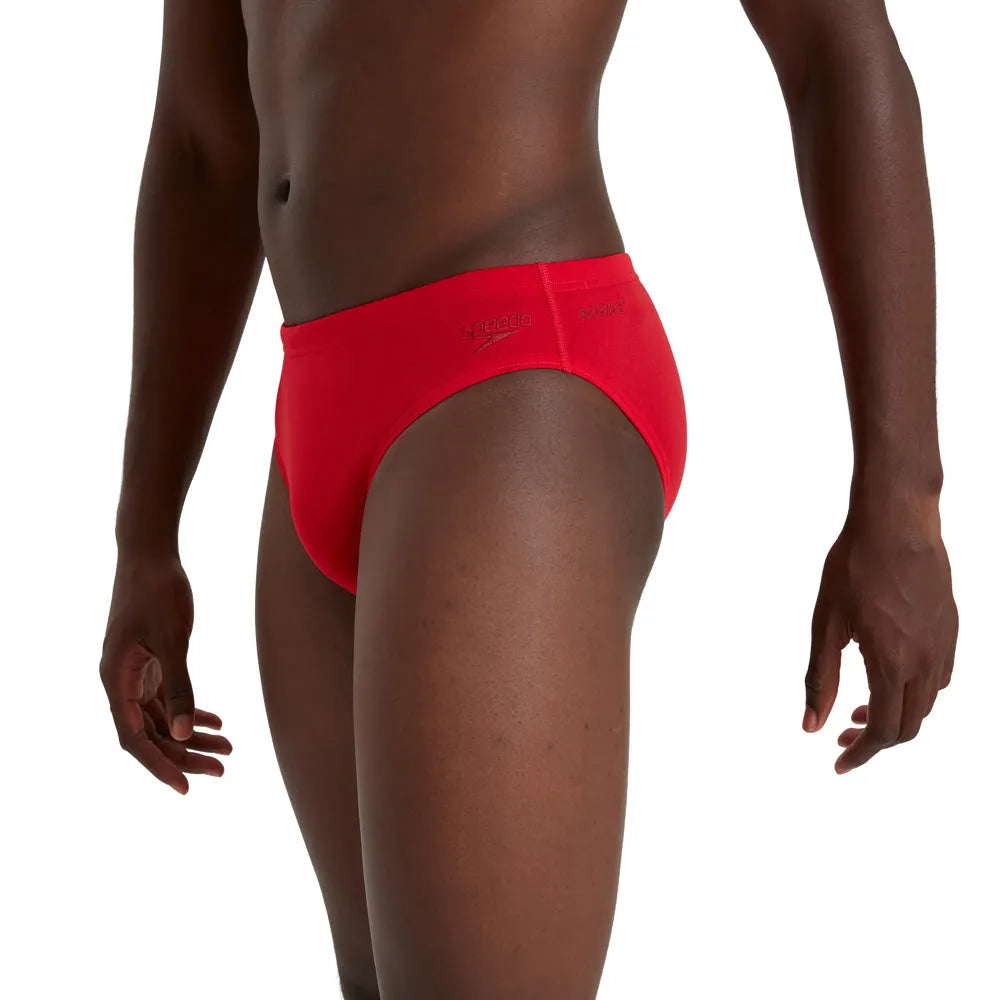 Red Speedo men's Eco Endurance+ 7cm brief, swimwear with a snug fit and durable fabric, shown on a plain background.