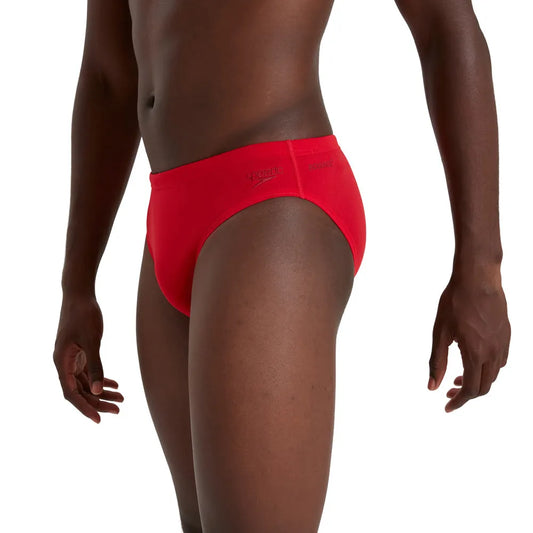 Red Speedo men's Eco Endurance+ 7cm brief, swimwear with a snug fit and durable fabric, shown on a plain background. 1000