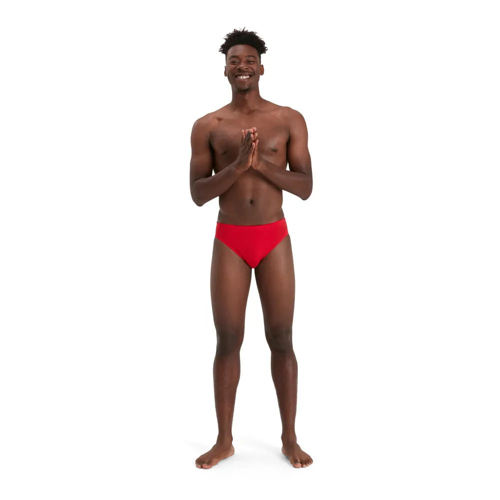 Red Speedo Men's Eco Endurance+ 7cm Briefs shown on model, highlighting the snug fit and sporty design of these swim briefs.