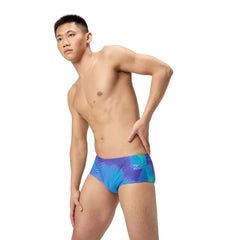 Speedo men's printed 13.5cm briefs in Under Current and Sugar Blue, featuring colorful abstract design and snug fit.