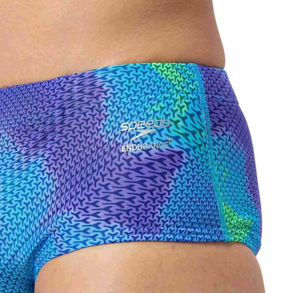 Speedo men's printed 13.5cm briefs in Under Current and Sugar Blue, featuring colorful swimwear design and comfortable fit.
