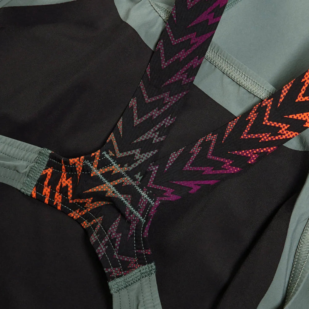 Speedo Women's Fastskin LZR Ignite Kneeskin in green and orange, close-up of the sleek, fitted swimwear designed for performance.