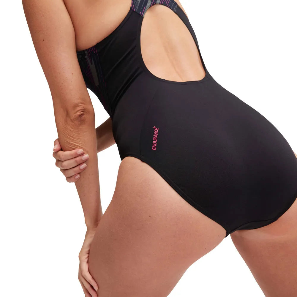 Speedo Women's HyperBoom Splice Muscleback swimsuit in black, electric pink, and USA charcoal, featuring a sleek, athletic design.